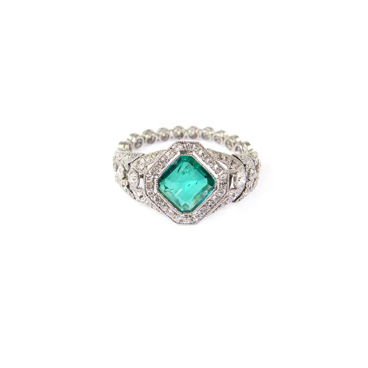Early 20th century emerald and diamond cluster ring with flexible shank